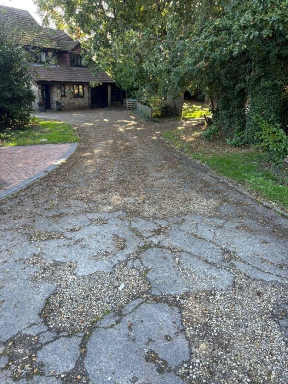 Worn, cracked driveway before resurfacing